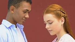 Mixed-Race Male Teen Hesitantly Touching Shy Girl Shoulder, First Feelings, Love