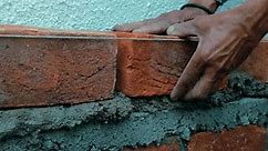 indian labor in construction site making manual Plumb Bob measurement calculating distance from the brick wall