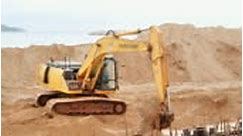 Excavator machine with shovel loading ground to tipper truck on...