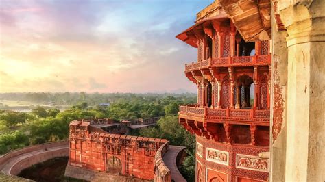 Agra Fort made of red sandstone and marble with view of cityscape at sunrise, India | Windows ...