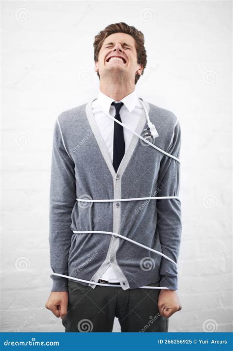 All Tied Up at Work. a Young Nerdy Guy with a Cable Wrapped Around Him ...