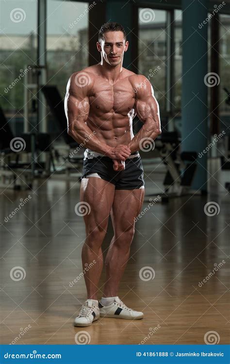 Handsome Body Builder Making Most Muscular Pose Stock Photo - Image of ...