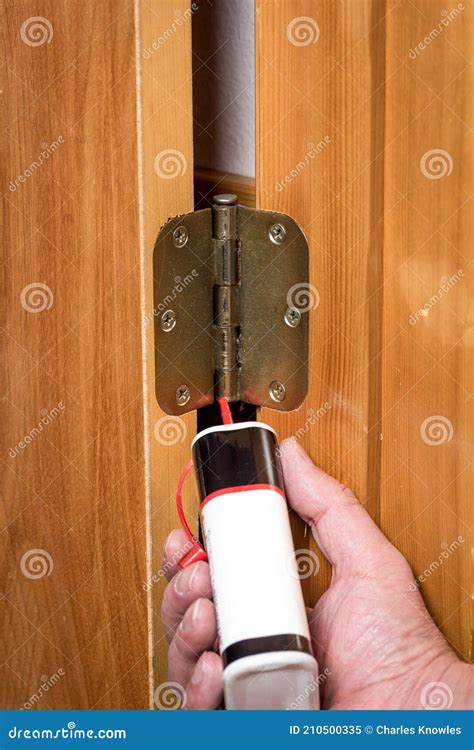 Man Applies Oil To a Squeaky Hinge Stock Image - Image of lubricate ...