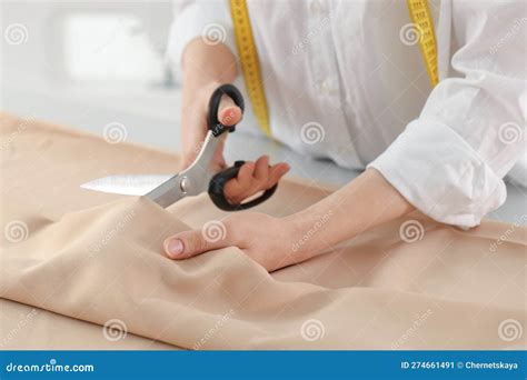 Dressmaker Cutting Fabric with Scissors at Table in Atelier, Closeup ...
