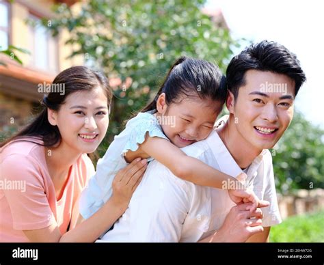Happy family of three in the outdoor smiling Stock Photo - Alamy