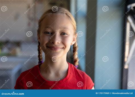 Schoolgirl with Blonde Hair in Plaits Looking To Camera in an ...