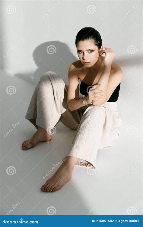 Barefoot Woman Sitting on the Floor Leaning Against the Wall Indoors Pants Style Suit Stock ...