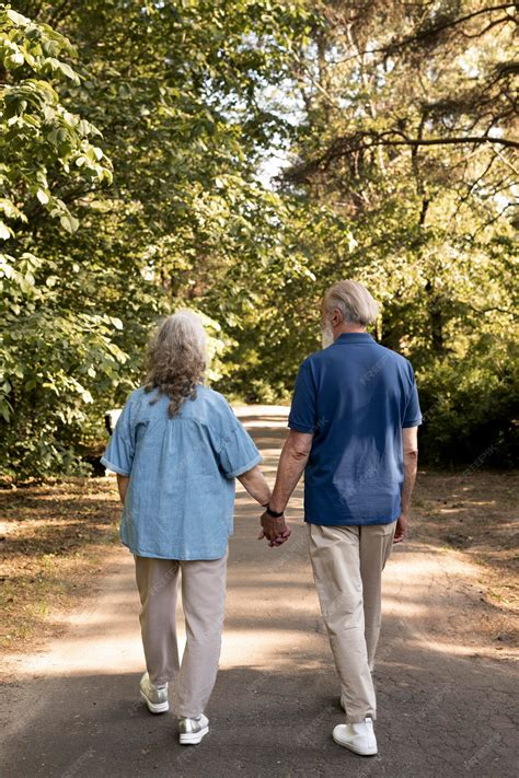 Old Couple Walking Hand In Hand