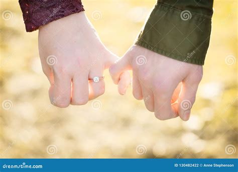 An Engaged Man and Woman Hold Pinkie Fingers Showing Their Love. Stock ...