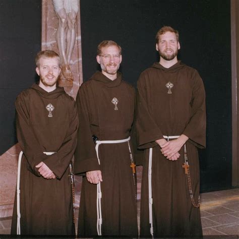 three men in brown robes standing next to each other with their hands ...