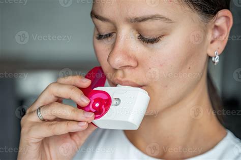Close up view of woman using medicine dry powder inhaler for treatment ...