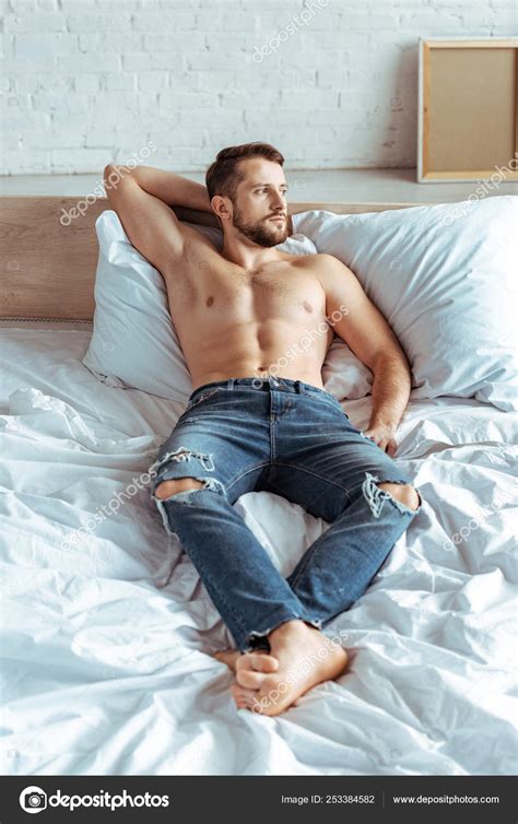 Handsome Muscular Man Lying Bed Looking Away Bedroom Stock Photo by ...