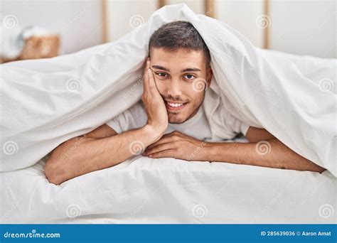Young Hispanic Man Covering with Sheet Lying on Bed at Bedroom Stock ...
