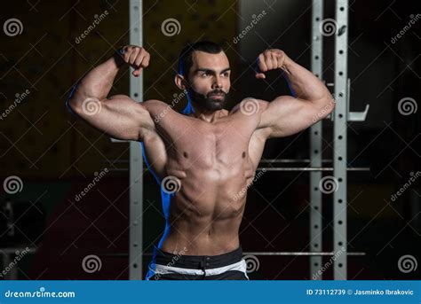 Bodybuilder Flexing Front Double Biceps Pose Stock Image - Image of ...