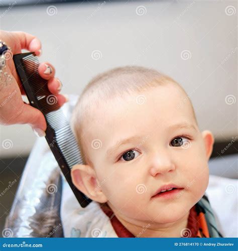 The Hairdresser Cuts the Toddler Baby Boy in the Barbershop. Child ...