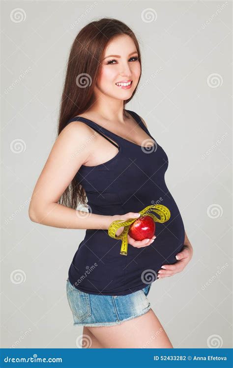 Pregnant Woman with Apple and Measuring Tape Stock Photo - Image of ...