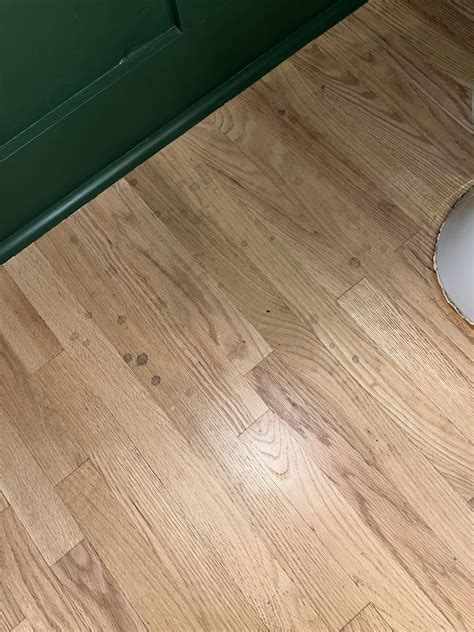 What is going on here? Spots on light hardwood in bathroom…they’re ...