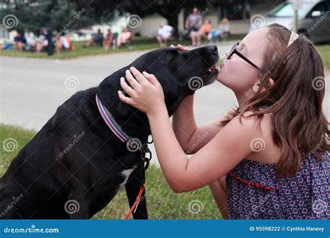 Girl kissing dog stock photo. Image of love, young, tongue - 95598222