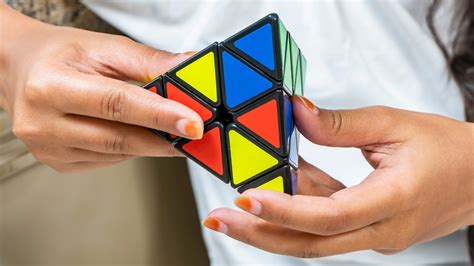 The Science Behind the Pyraminx / Triangle Rubik’s Cube: Geometry, Alg