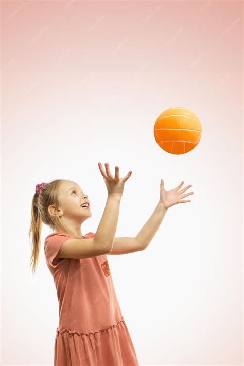 Premium Photo | A cute happy girl throwing a ball