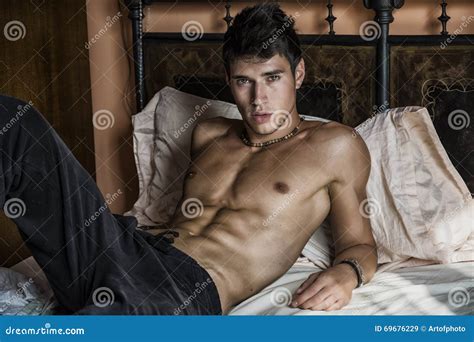 Shirtless Male Model Lying Alone on His Bed Stock Image - Image of ...