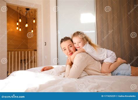 Mom and Daughter Have Fun in the Bedroom. Stock Image - Image of ...