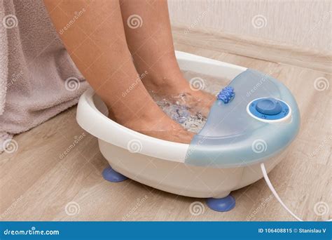 Female Feet in a Vibrating Foot Massager. Electric Massage Foot Bath ...