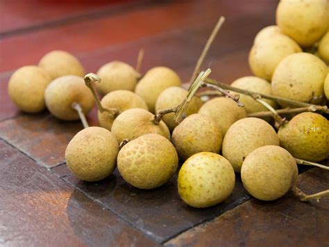 Download Longan Fruits Scattered On The Table Wallpaper | Wallpapers.com