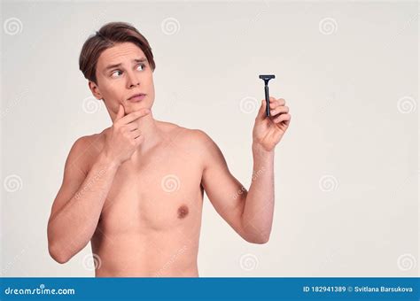 Pensive Young Naked Guy with a Razor in His Hand, after a Shower Stock ...