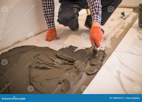 Troweling Mortar Onto A Concrete Floor In Preparation For Floor Tile ...