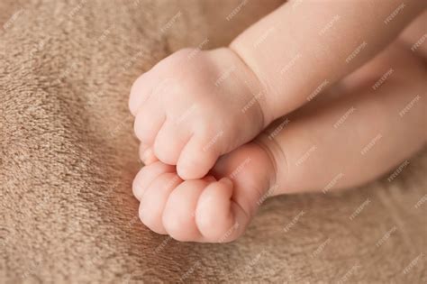Premium Photo | The hand of a newborn clenched into a fist health care ...
