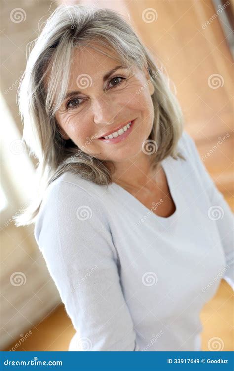 Pretty Mature Woman Standing at Home Stock Image - Image of retirement ...