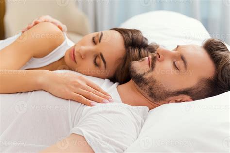 Feeling calm and comfortable. Beautiful loving couple sleeping together ...
