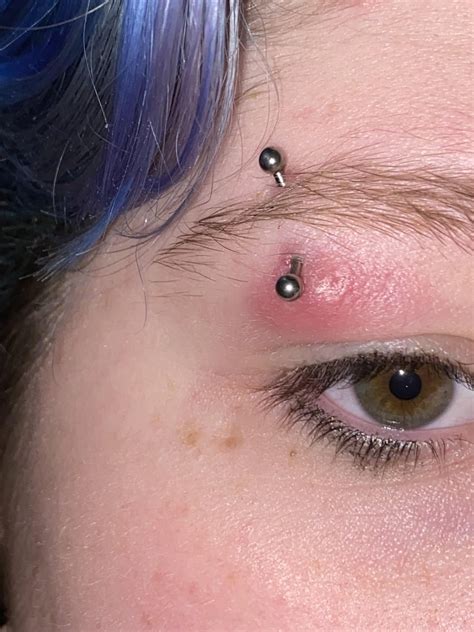 is my eyebrow piercing infected? do i need to take it out? : r ...