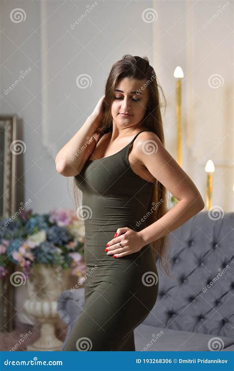 Young Brunette Woman with Big Breasts and Tight Dress Stock Photo ...