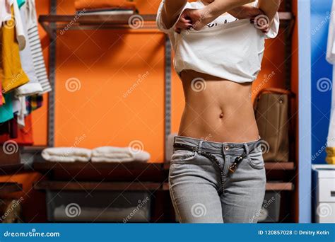 Young Woman Take Off Her T-shirt in Wardrobe. Stock Photo - Image of ...