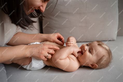 Free Photo | Side view mother tickling baby