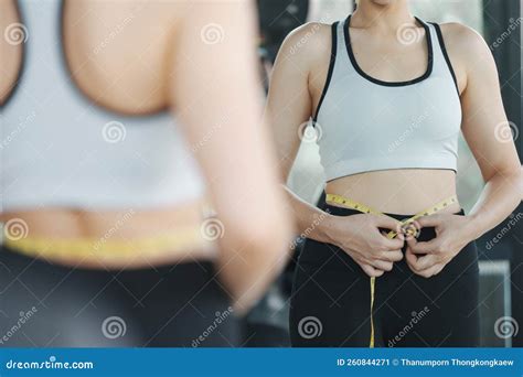Young Woman Measuring Her Waist by Measure Tape at the Gym Stock Image ...