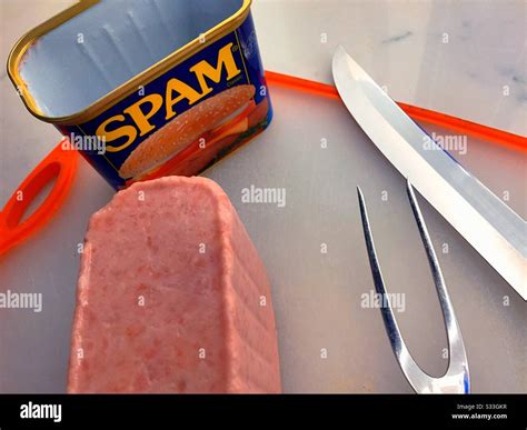 Freshly opened a can of Spam luncheon meat and carving set on a cutting ...
