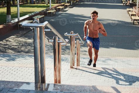 Muscular shirtless man have fitness day and running in the city at ...