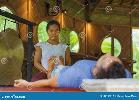 Young Beautiful and Exotic Asian Balinese Wellness Therapist Giving ...