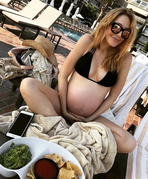 Download Pregnant Woman Relaxing Poolside Wallpaper | Wallpapers.com