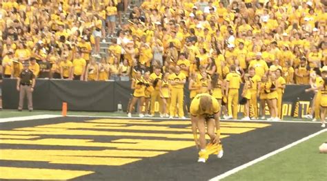 Moment Cheerleader suffers wardrobe malfunction mid college football routine leaving fans ...