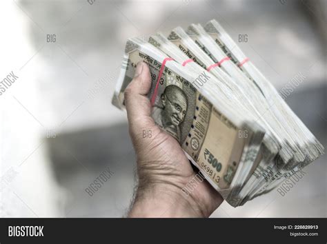 Currency In A Mans Hand - HooDoo Wallpaper