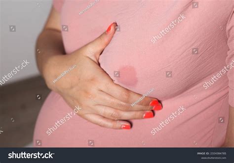 7개의 A soaked blouse from milk on the female breast of a nursing mother ...