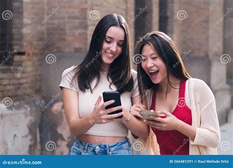 Women Laughing Funny Looking at Their Cell Phones Stock Image - Image ...