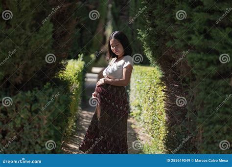 Young Happy and Beautiful Asian Chinese Woman Posing Outdoors Happy and Cheerful at City Park ...