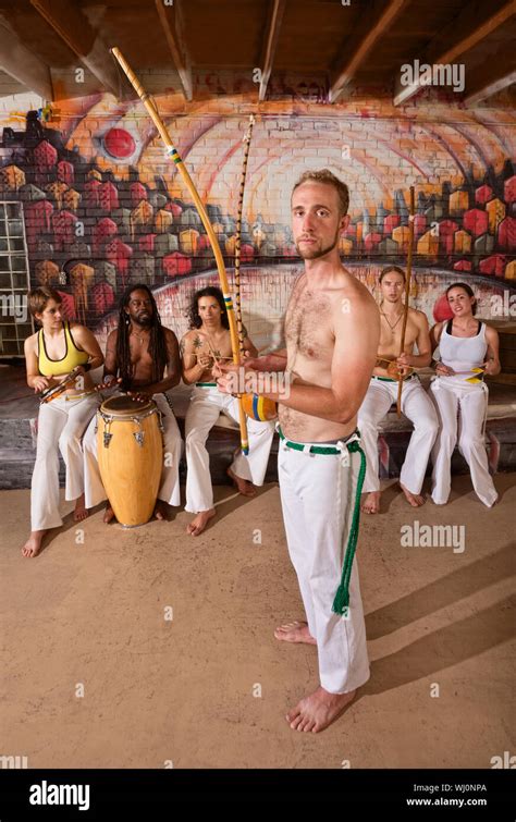 European capoeira performers with group playing music indoors Stock ...