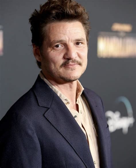 a man in a suit posing for the camera