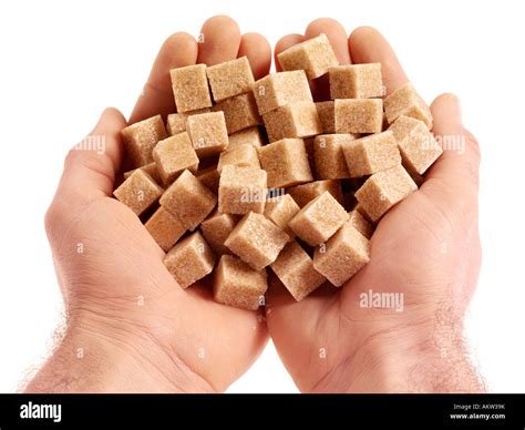 HANDFUL OF DEMERARA SUGAR CUBES Stock Photo - Alamy